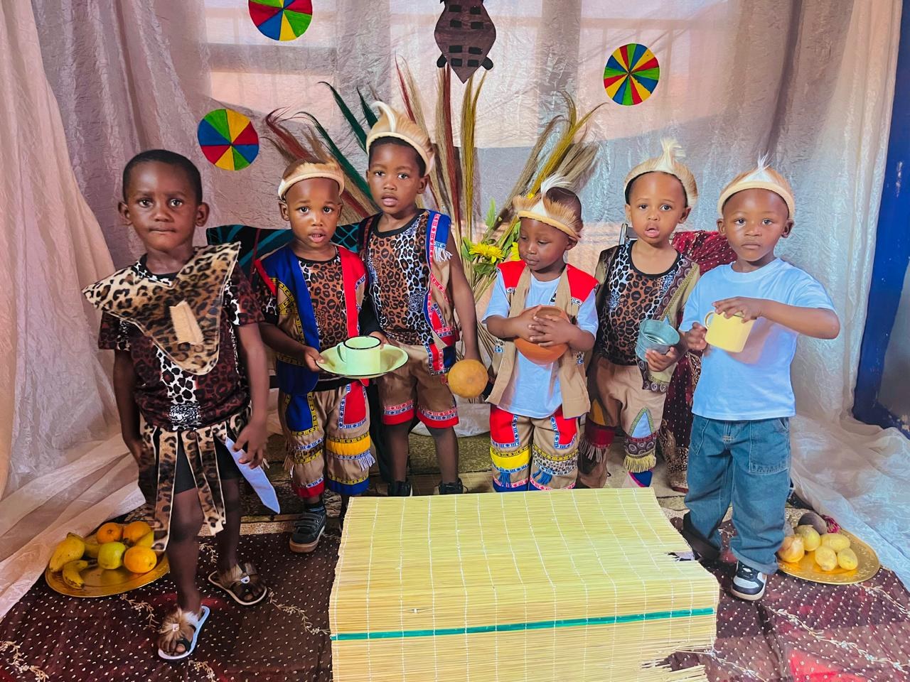 Six children in traditional leopard-print and beaded outfits for Heritage Day