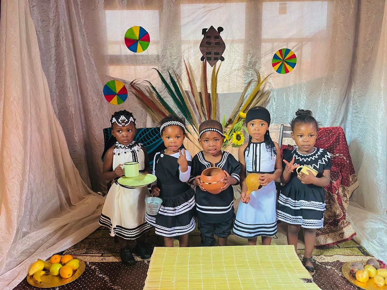 Five children in traditional beaded outfits for Heritage Day